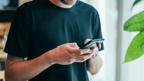 A man typing a message on his phone